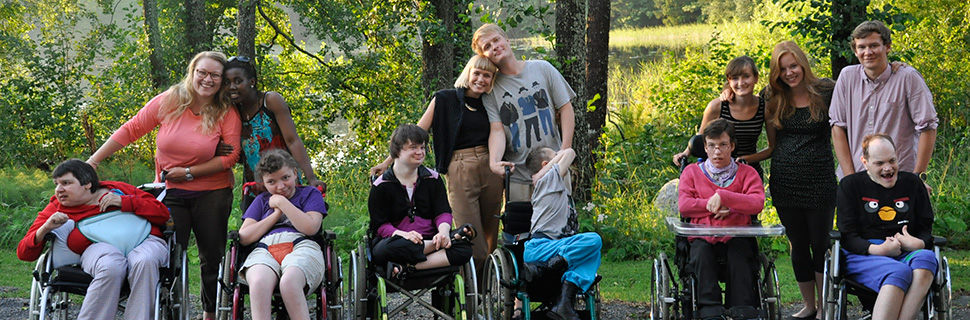 Intellectually disabled people at a summer camp together with staff.